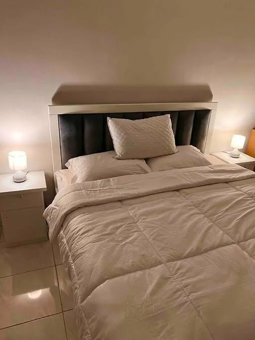 A Cozy Bedroom With A Desk Riyadh